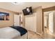 This bedroom features tile floors, a mounted tv, and a closet at 9031 N 14Th St, Phoenix, AZ 85020