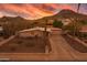 Charming single-story home features a desert landscape, an attached garage, and mountain views under a vibrant sunset at 9031 N 14Th St, Phoenix, AZ 85020