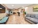 Open-concept living room with tile floors and a bar area leading to the kitchen at 9031 N 14Th St, Phoenix, AZ 85020