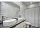 This bathroom features a double vanity with vessel sinks, decorative tile backsplash, and a shower/tub combo at 9543 W Donald Dr, Peoria, AZ 85383