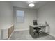 This modern office features a grey desk, tile floors, and stylish built-in storage at 9543 W Donald Dr, Peoria, AZ 85383