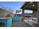 Outdoor kitchen and dining area overlooking the inviting pool and stylish patio at 9543 W Donald Dr, Peoria, AZ 85383