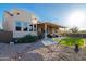 Expansive backyard with artificial turf, hammock, covered patio, and desert landscaping, ideal for outdoor living and entertaining at 10142 E La Palma Ave, Gold Canyon, AZ 85118
