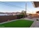 Backyard featuring artificial turf, gravel landscaping, a hammock, and mountain views, perfect for relaxation and outdoor enjoyment at 10142 E La Palma Ave, Gold Canyon, AZ 85118