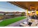 Backyard with turf lawn, covered patio, outdoor seating, and mountain views at 10142 E La Palma Ave, Gold Canyon, AZ 85118