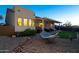 Scenic backyard includes a hammock, covered patio, manicured turf, and beautiful mountain views at 10142 E La Palma Ave, Gold Canyon, AZ 85118