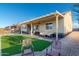 Spacious backyard with artificial turf, covered patio, and comfortable seating, perfect for outdoor relaxation and entertaining at 10142 E La Palma Ave, Gold Canyon, AZ 85118