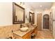 Spacious bathroom featuring dual sinks with vessel bowls and granite counters, tiled accent wall at 10142 E La Palma Ave, Gold Canyon, AZ 85118