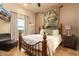 Comfortable bedroom with a queen bed, decorative wall tapestry, and a view of the front yard at 10142 E La Palma Ave, Gold Canyon, AZ 85118
