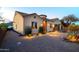 Inviting exterior with decorative lighting, desert landscaping, and a paved driveway leading to the charming home at 10142 E La Palma Ave, Gold Canyon, AZ 85118