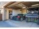 Spacious garage featuring a car, off road vehicle, ample storage cabinets, and convenient access, perfect for vehicle enthusiasts at 10142 E La Palma Ave, Gold Canyon, AZ 85118