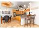 Charming kitchen with wooden cabinets, granite countertops, and a view to the dining area at 10142 E La Palma Ave, Gold Canyon, AZ 85118