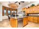 Bright kitchen with an island, stainless steel appliances, and an adjacent dining area at 10142 E La Palma Ave, Gold Canyon, AZ 85118