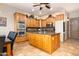 Kitchen with wooden cabinets, stainless steel double oven, granite countertops and tile floors at 10142 E La Palma Ave, Gold Canyon, AZ 85118