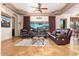 Spacious living room featuring leather sofas, decorative ceiling, and scenic views at 10142 E La Palma Ave, Gold Canyon, AZ 85118