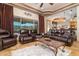Beautiful living room with large window view, coffered ceiling, and leather furniture at 10142 E La Palma Ave, Gold Canyon, AZ 85118