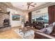 Comfortable living room with a stone fireplace, leather seating, and scenic mountain views at 10142 E La Palma Ave, Gold Canyon, AZ 85118