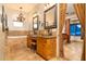 Main bathroom with double sinks, a chandelier, bathtub, tile floors, and backyard view at 10142 E La Palma Ave, Gold Canyon, AZ 85118