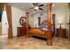 Elegant main bedroom featuring a four-poster bed, tile floors, and decorative furnishings at 10142 E La Palma Ave, Gold Canyon, AZ 85118
