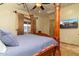 View of the main bedroom showing a four-poster bed, large windows, and tile floors at 10142 E La Palma Ave, Gold Canyon, AZ 85118