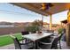 Outdoor patio area with a dining table and chairs, artificial turf, and mountain views at 10142 E La Palma Ave, Gold Canyon, AZ 85118