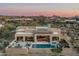 Stunning aerial view of the property showcasing the pool, patio, and lush desert surroundings at 10238 E Rising Sun Dr, Scottsdale, AZ 85262