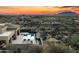 Elevated perspective of the house, pool, and spa seamlessly integrated into the vast, scenic desert landscape at 10238 E Rising Sun Dr, Scottsdale, AZ 85262