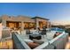 Expansive backyard with an outdoor kitchen, pool, lounge and beautiful desert views at 10238 E Rising Sun Dr, Scottsdale, AZ 85262
