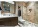 Bathroom with vanity, toilet, and a tiled walk-in shower with glass door at 10238 E Rising Sun Dr, Scottsdale, AZ 85262