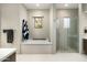 Bright bathroom features a soaking tub, a walk-in shower, and neutral paint at 10238 E Rising Sun Dr, Scottsdale, AZ 85262
