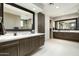 Bathroom has dual vanities and sinks with modern fixtures and a large walk in shower at 10238 E Rising Sun Dr, Scottsdale, AZ 85262
