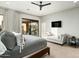 Bedroom with a queen size bed and view to outdoor balcony and TV sitting area at 10238 E Rising Sun Dr, Scottsdale, AZ 85262