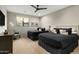 Bedroom with two beds, large windows, neutral walls, and a ceiling fan at 10238 E Rising Sun Dr, Scottsdale, AZ 85262
