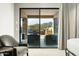 Bright bedroom with a sliding glass door to a private patio with mountain views at 10238 E Rising Sun Dr, Scottsdale, AZ 85262