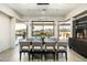 Inviting dining room with a large wooden table, comfortable seating, and desert views at 10238 E Rising Sun Dr, Scottsdale, AZ 85262
