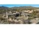 Expansive desert home boasts a grand driveway, three-car garage, and modern design set amidst natural beauty at 10238 E Rising Sun Dr, Scottsdale, AZ 85262