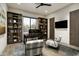 Bright home office with dark wood shelving, a large window and an elegant workstation at 10238 E Rising Sun Dr, Scottsdale, AZ 85262
