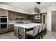 Well-equipped kitchen featuring a central island, stainless steel appliances, and built-in wine cooler at 10238 E Rising Sun Dr, Scottsdale, AZ 85262