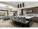 Modern kitchen with a large island, stainless steel appliances, and dining area with mountain views at 10238 E Rising Sun Dr, Scottsdale, AZ 85262