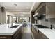 Elegant kitchen showcasing a center island, modern appliances, and an adjacent dining area with scenic views at 10238 E Rising Sun Dr, Scottsdale, AZ 85262