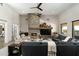 Living room features a cozy stone fireplace, modern furniture, and stylish décor at 10238 E Rising Sun Dr, Scottsdale, AZ 85262