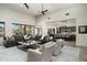Spacious living room featuring high ceilings, modern decor, and an open layout flowing into the kitchen at 10238 E Rising Sun Dr, Scottsdale, AZ 85262