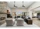 Spacious living room with stone fireplace and large view windows at 10238 E Rising Sun Dr, Scottsdale, AZ 85262