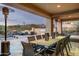 Outdoor dining area with a long table, grill, heat lamps and scenic views at 10238 E Rising Sun Dr, Scottsdale, AZ 85262