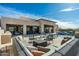Spacious outdoor patio with a full seating arrangement, a grill, and a fireplace, ideal for socializing at 10238 E Rising Sun Dr, Scottsdale, AZ 85262