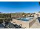 Tranquil backyard pool area with lounge chairs, surrounded by natural desert landscape and mountain views at 10238 E Rising Sun Dr, Scottsdale, AZ 85262