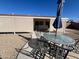 A patio and backyard area with chairs, a table, and a large umbrella at 10402 N Balboa Dr, Sun City, AZ 85351