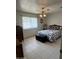 Inviting bedroom with a comfortable bed, tile flooring, and ample natural light at 10402 N Balboa Dr, Sun City, AZ 85351