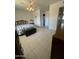 Bedroom featuring tile floors, and easy access to the en-suite bathroom at 10402 N Balboa Dr, Sun City, AZ 85351