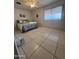 This bedroom has a ceiling fan, large window and tile flooring at 10402 N Balboa Dr, Sun City, AZ 85351